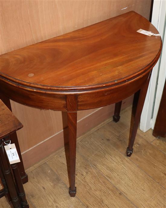 A George III style inlaid mahogany D shaped folding tea table W.80cm